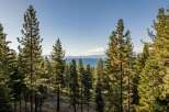 Experience breathtaking lake views from this stunning property, nestled amidst a serene pine forest.