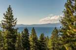 Experience breathtaking lake views framed by majestic pine trees from this stunning property.