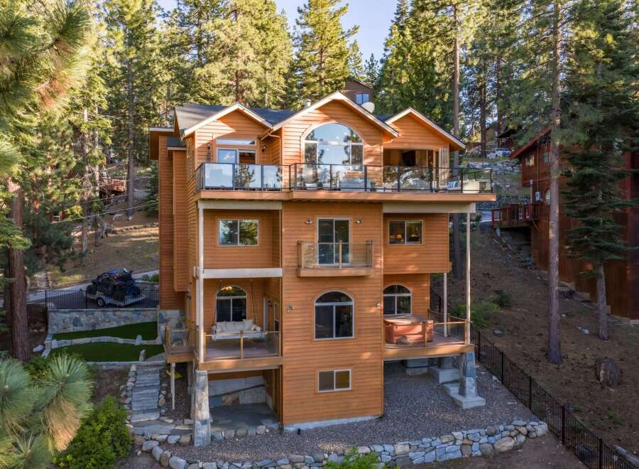 Experience luxury mountain living in this stunning multi-level home nestled among tall pine trees.