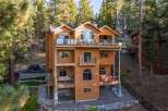 Experience luxury mountain living in this stunning multi-level home nestled among tall pine trees.