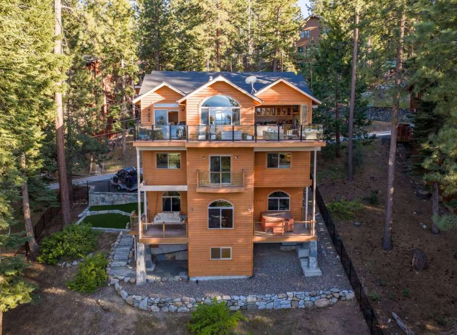 Experience luxury mountain living in this stunning multi-level home nestled among tall pine trees.