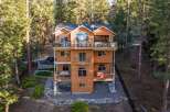 Experience luxury mountain living in this stunning multi-level home nestled among tall pine trees.