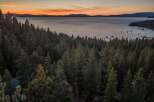Experience breathtaking sunset views over Lake Tahoe from this stunning property nestled amongst towering pine trees.