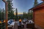 Experience breathtaking sunset views from this stunning mountain retreat's expansive deck, complete with a cozy fire pit and comfortable seating.