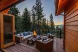 Experience breathtaking sunset views from this stunning deck, complete with a cozy fire pit and comfortable outdoor seating.