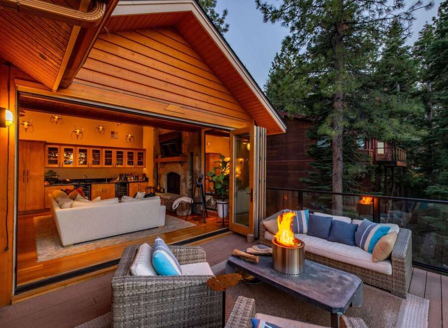 Experience seamless indoor-outdoor living with this stunning property, featuring a spacious deck with a fire pit perfect for entertaining.