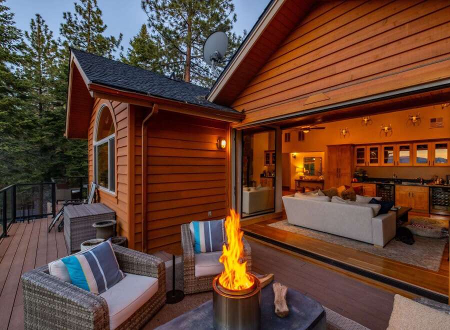 Experience seamless indoor-outdoor living with this stunning property, featuring a spacious deck with a cozy fire pit perfect for evening relaxation.