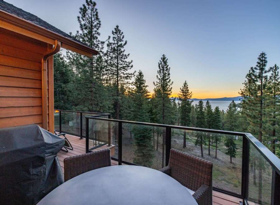 Enjoy breathtaking lake views from this stunning property's expansive deck, perfect for entertaining or quiet relaxation.