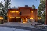 Experience rustic charm with this stunning wooden home, featuring playful bear sculptures adorning the roof and exterior.