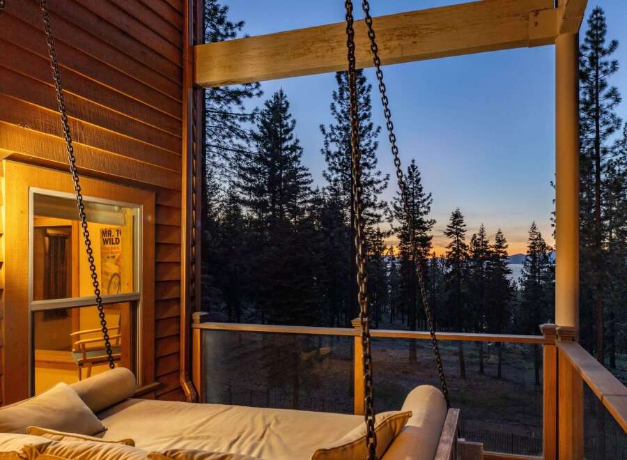 Experience breathtaking sunset views from this stunning porch swing, perfect for relaxing evenings.