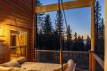 Experience breathtaking sunset views from this stunning porch swing, perfect for relaxing evenings.