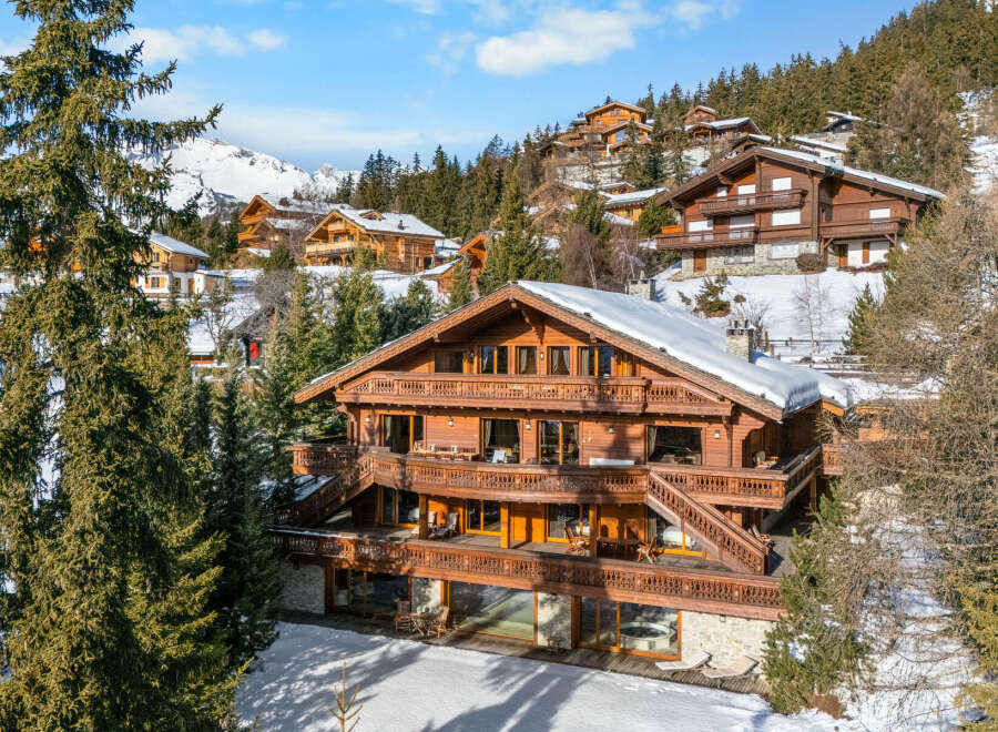 Experience luxury mountain living in this stunning wooden chalet, nestled amidst snow-covered peaks and evergreen forests.