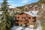 Experience luxury mountain living in this stunning wooden chalet, nestled amidst snow-covered peaks and evergreen forests.
