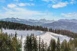 Experience breathtaking mountain views from this stunning property, nestled amidst a pristine winter landscape.
