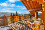 Experience breathtaking mountain vistas from this stunning wooden balcony, perfect for enjoying your morning coffee or evening relaxation.