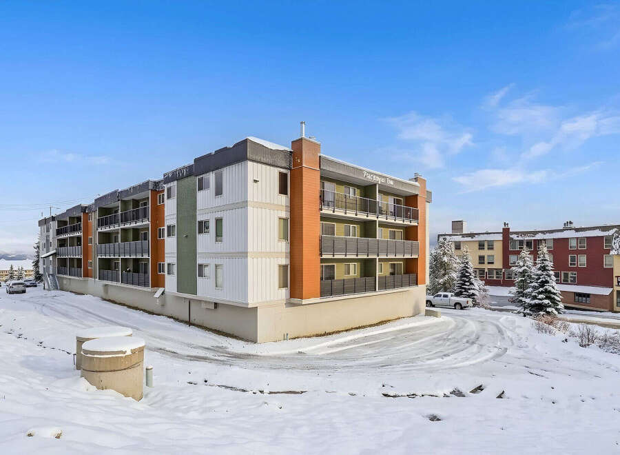 Discover modern living in this multi-story apartment building, featuring a sleek design with balconies on each level.