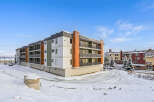 Discover modern living in this multi-story apartment building, featuring a sleek design with balconies on each level.