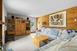 Cozy living room featuring a spacious sectional sofa adorned with decorative pillows and a plaid throw blanket.