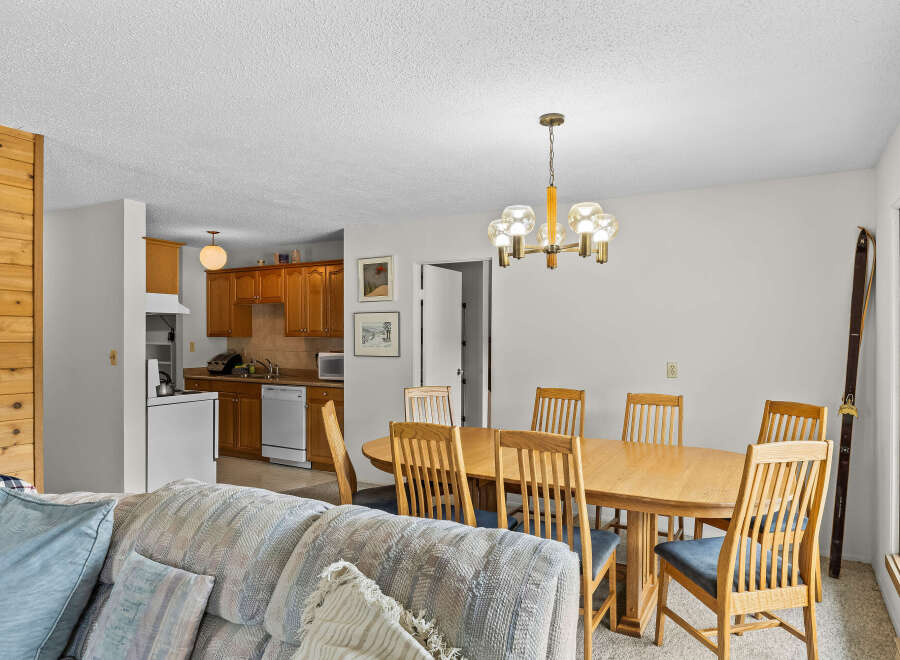 This open-concept living space seamlessly blends a cozy living area with a functional kitchen and dining space.