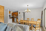 This open-concept living space seamlessly blends a cozy living area with a functional kitchen and dining space.