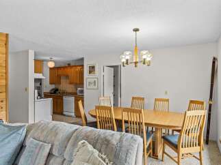 This open-concept living space seamlessly blends a cozy living area with a functional kitchen and dining space.