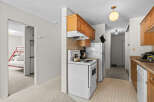 Discover this charming kitchen featuring warm wooden cabinetry and a functional white stove.