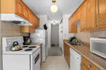 This charming kitchen features warm oak cabinetry and a practical layout, perfect for everyday cooking.