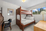 This charming bedroom features a sturdy wooden bunk bed, perfect for accommodating guests or family.