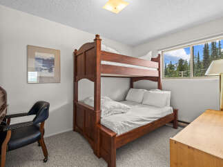 This charming bedroom features a sturdy wooden bunk bed, perfect for accommodating guests or family.