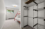 This charming bedroom features a space-saving red bunk bed, perfect for families or guests.