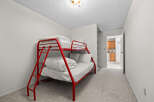 This charming bedroom features a vibrant red bunk bed, perfect for accommodating guests or children.