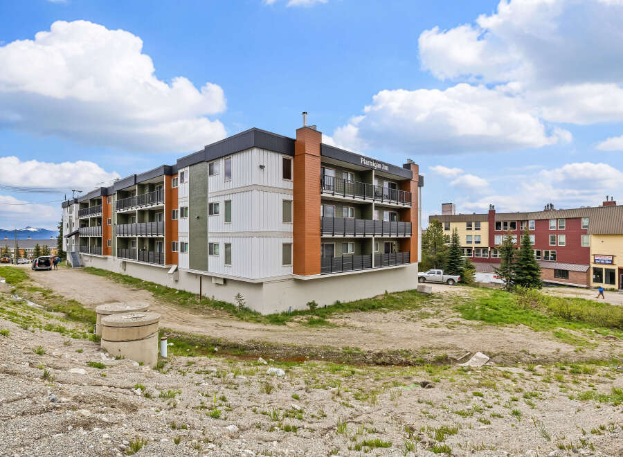 Discover modern living at Ptarmigan Inn, a contemporary apartment building offering stylish units with private balconies and scenic views.