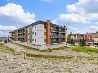 Discover modern living at Ptarmigan Inn, a contemporary apartment building offering stylish units with private balconies and scenic views.