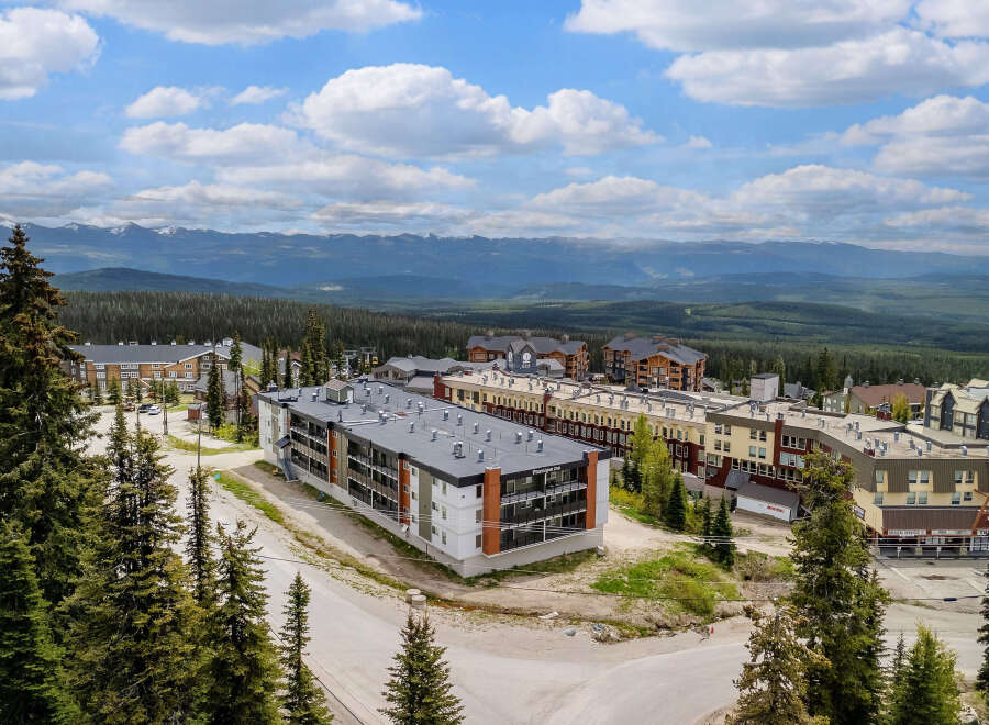 Discover this stunning mountain resort property offering modern condominium living with breathtaking panoramic views of snow-capped peaks and lush evergreen forests.