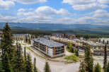 Discover this stunning mountain resort property offering modern condominium living with breathtaking panoramic views of snow-capped peaks and lush evergreen forests.