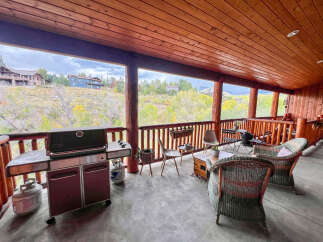 Enjoy breathtaking mountain views from this expansive covered deck, perfect for entertaining or relaxing.