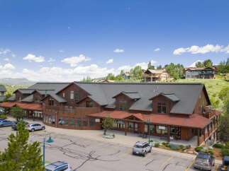 Discover this charming commercial building nestled in a picturesque mountain setting.