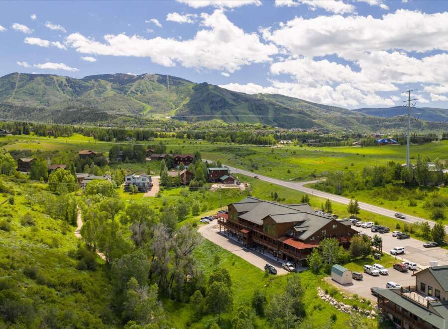 Discover this expansive property nestled amidst rolling green hills and majestic mountains.
