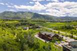 Discover this expansive property nestled amidst rolling green hills and majestic mountains.