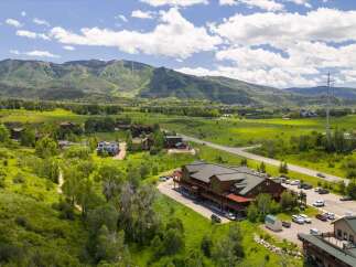 Discover this expansive property nestled amidst rolling green hills and majestic mountains.