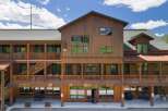Discover this charming multi-story wooden building, featuring multiple balconies and covered walkways perfect for enjoying the outdoors.