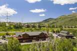 Discover this expansive property featuring a large, multi-story building with ample parking and scenic mountain views.