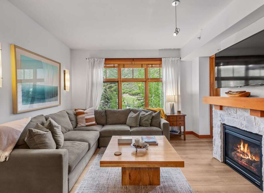 Experience cozy living in this inviting living room, featuring a plush sectional sofa perfect for relaxation.