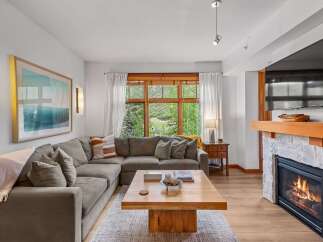 Experience cozy living in this inviting living room, featuring a plush sectional sofa perfect for relaxation.