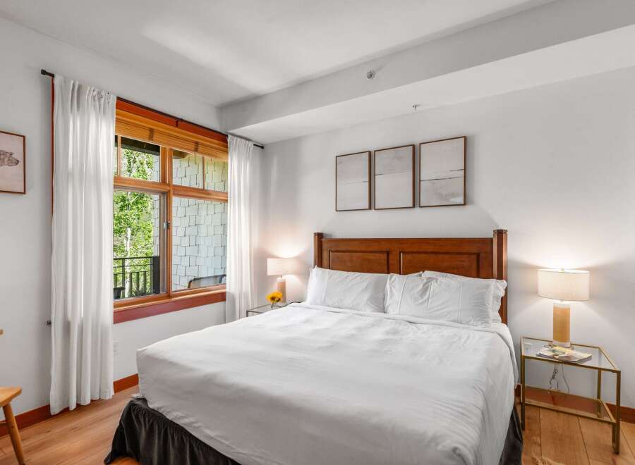 Experience comfort and style in this beautifully appointed bedroom, featuring a plush king-sized bed with crisp white linens.