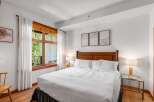 Experience comfort and style in this beautifully appointed bedroom, featuring a plush king-sized bed with crisp white linens.