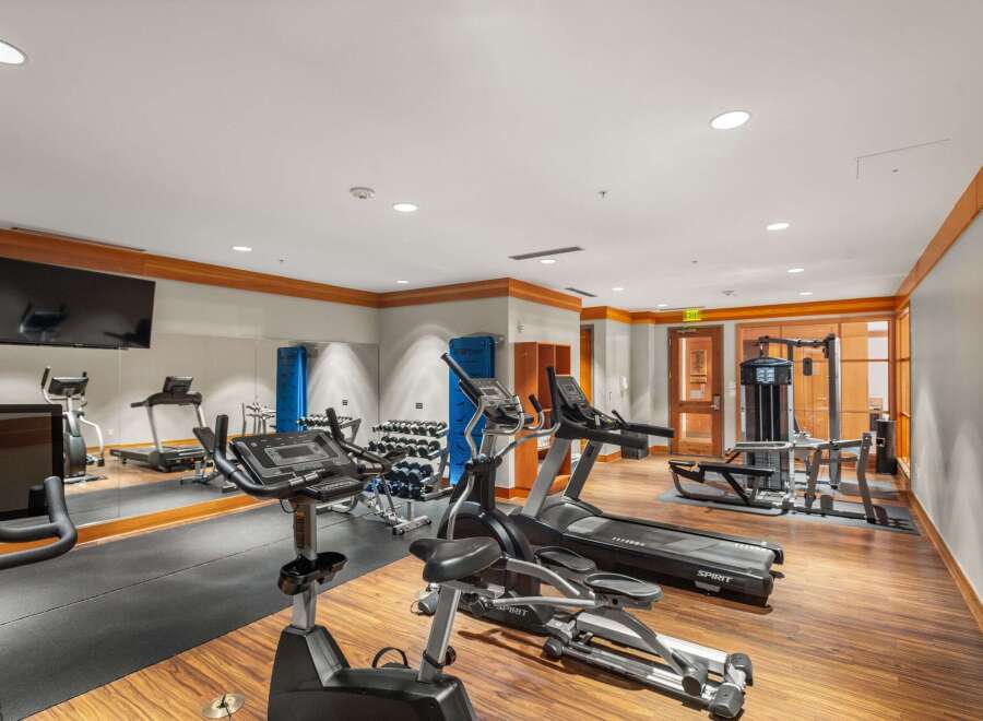 This well-equipped gym features a variety of cardio machines including treadmills and ellipticals, perfect for residents to maintain their fitness routines.
