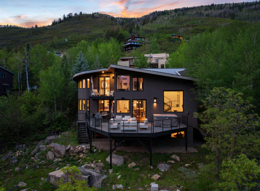 Experience luxury living in this stunning modern home nestled on a hillside, offering breathtaking views and an unparalleled connection to nature.