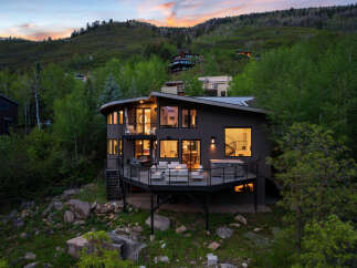 Experience luxury living in this stunning modern home nestled on a hillside, offering breathtaking views and an unparalleled connection to nature.