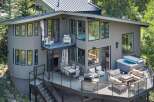 Experience luxury outdoor living with this stunning multi-level deck featuring a spacious hot tub and a cozy fire pit area, perfect for entertaining.